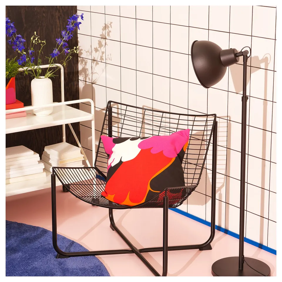 SKÅLBODA chair with colourful pillow and lamp.