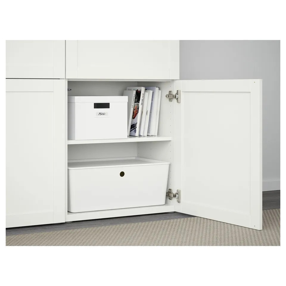 White BESTÅ cabinet with adjustable shelves and pull-out storage, featuring soft-close doors and organised storage boxes.