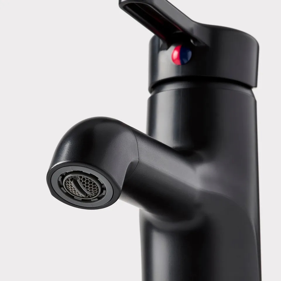 Black modern tap with sleek handles and a mesh-filtered spout, indicating high-quality design and functionality.