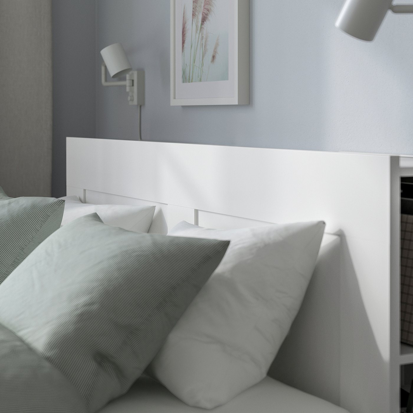 Modern bed with sleek white headboard, integrated storage, and wall lights.