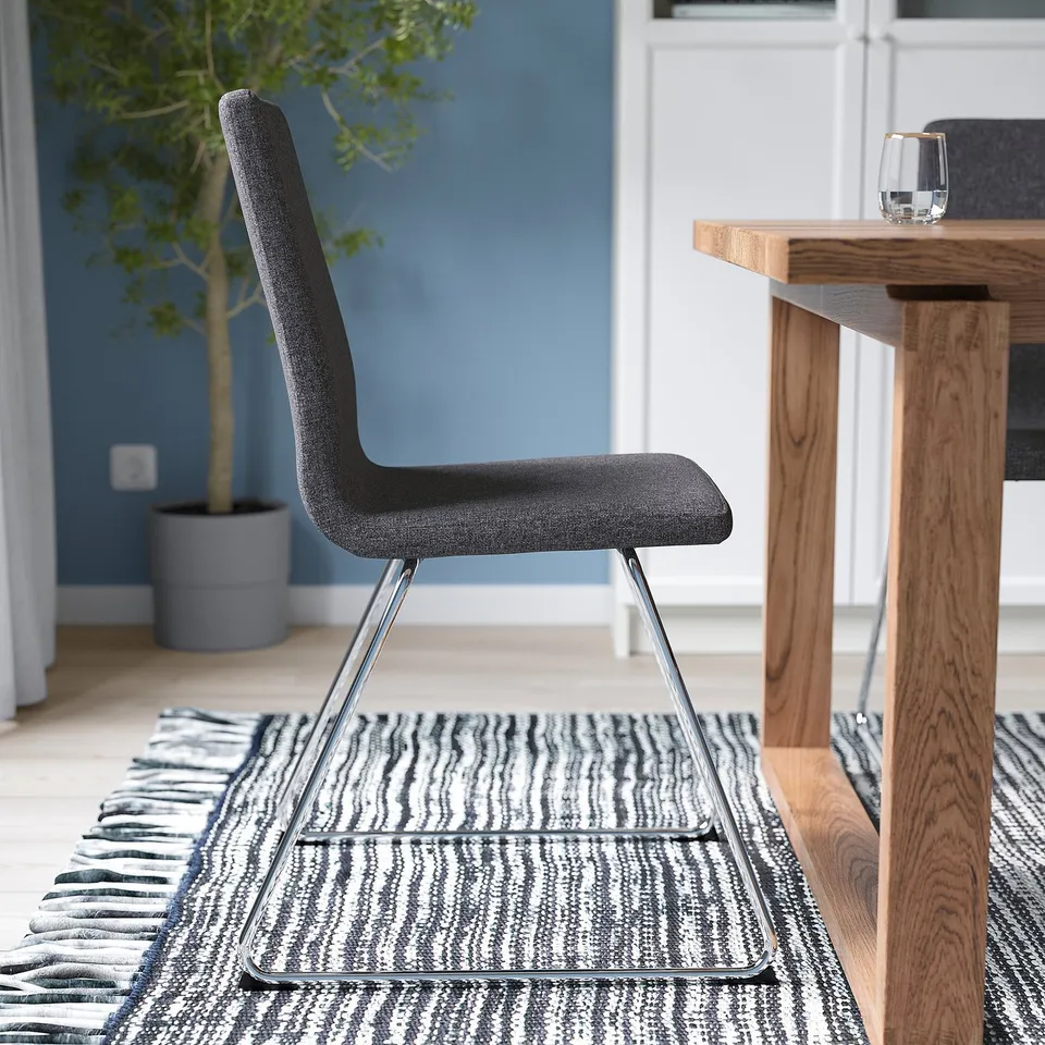 Modern grey LILLÅNÄS chair with padded seat and back, sleek chrome sled base, styled for comfort.