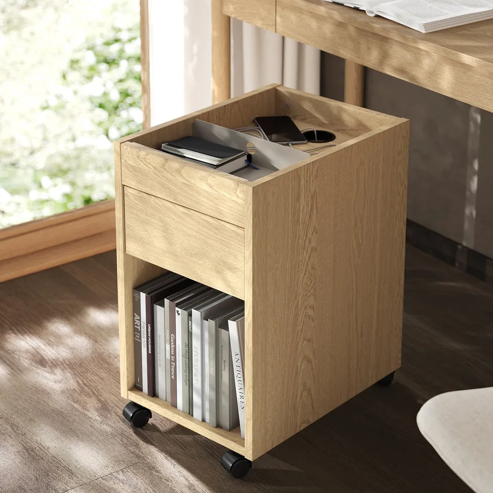 Wooden trolley with wheels holds books and files; fits under desk for storage.
