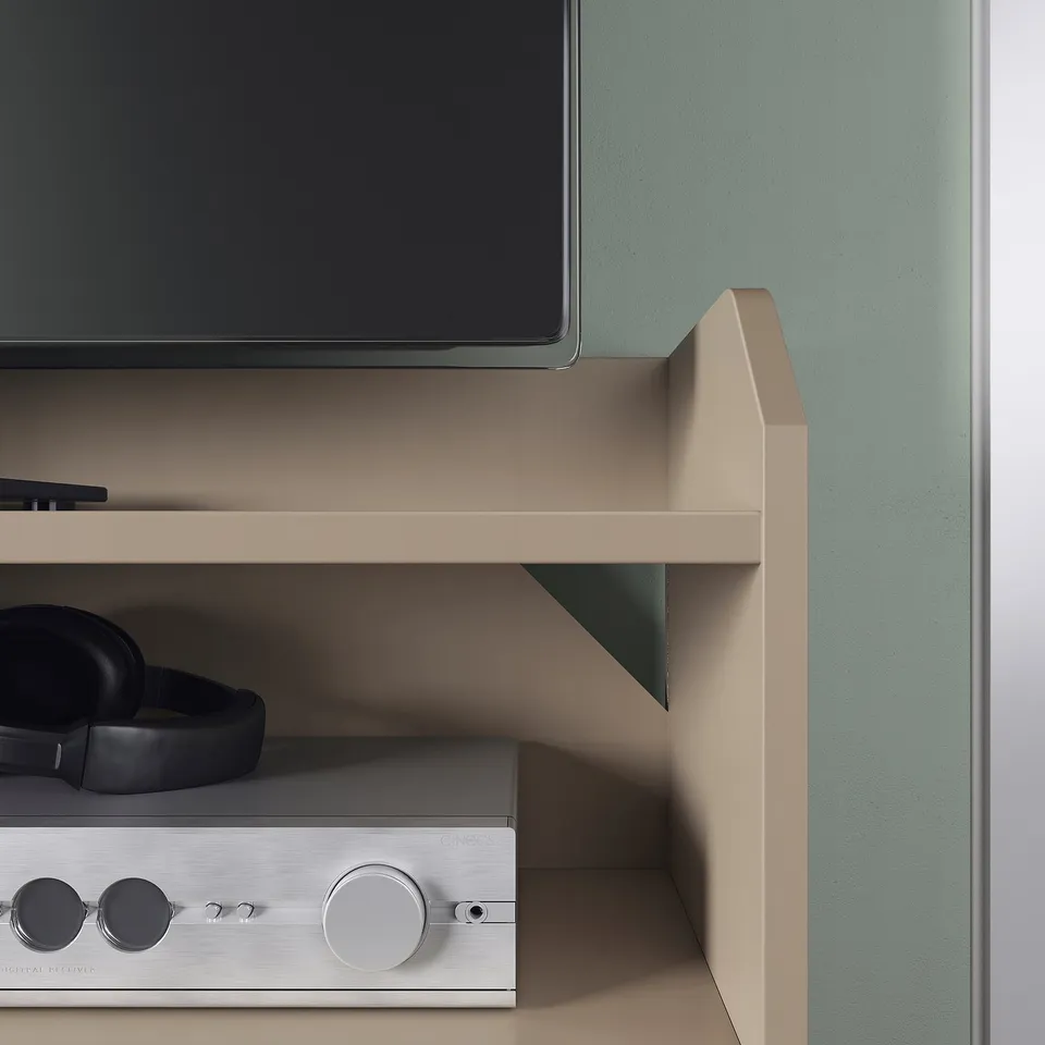 Modern tv stand with flat screen, headphones, and audio device on shelves. Quality construction, sleek design in neutral tone.