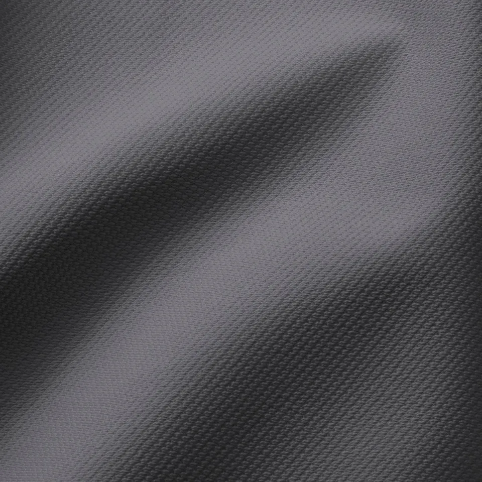Close-up of textured, two-tone fabric. Soft, woven hallarp material in shades of grey.