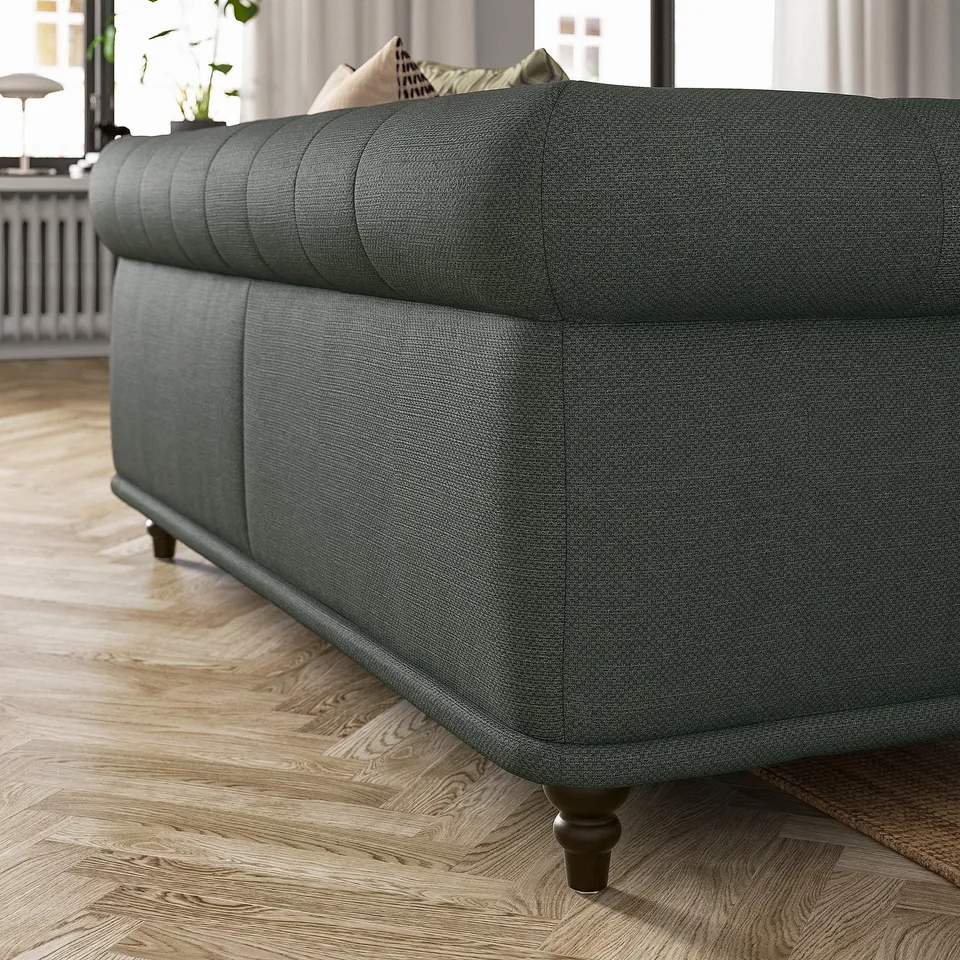 Grey sofa with classic design and rounded shapes in a living room.