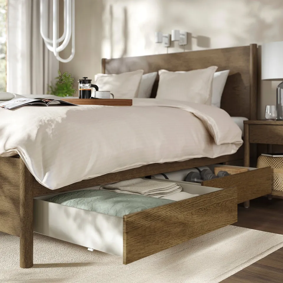 Modern bedroom with TONSTAD wooden bed, open drawers, and stylish storage on headboard.