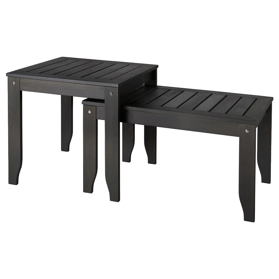 ÖRSKÄR black nest tables: 2 acacia wood tables, stackable, sleek design for outdoors.