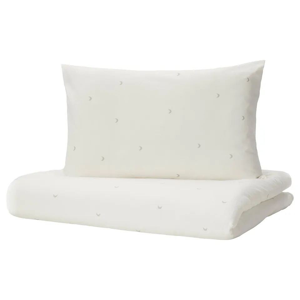 White baby bedding set with crescent moon design, made of soft cotton, rectangular shape.