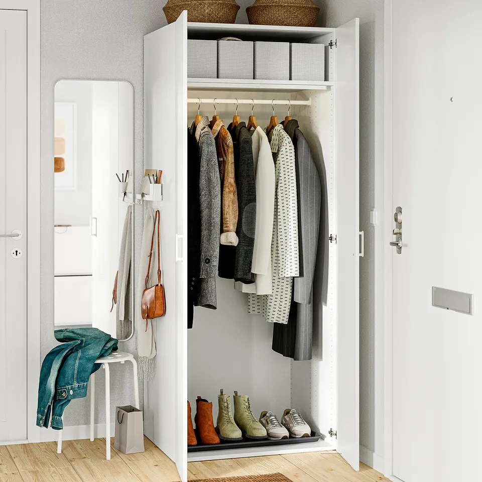 Organised closet with hanging clothes, shoes, and accessories, featuring adjustable feet and wall-mounted.