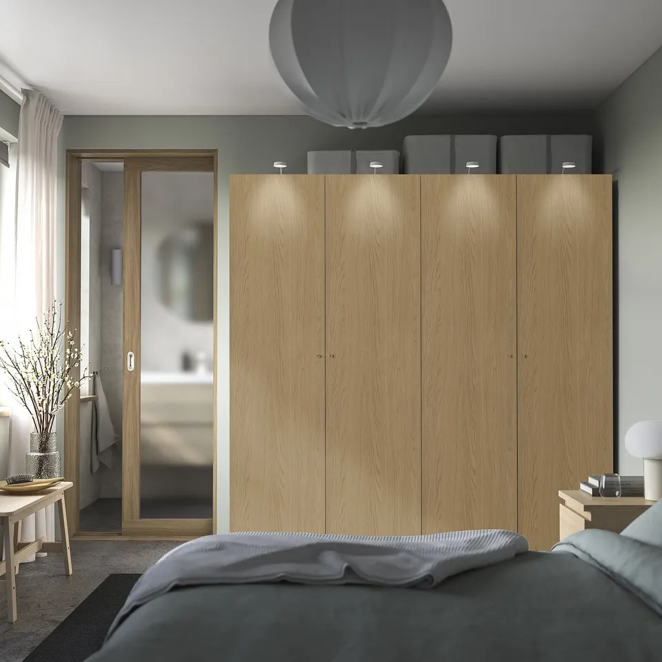 Modern bedroom with light wood PAX wardrobe, grey decor.