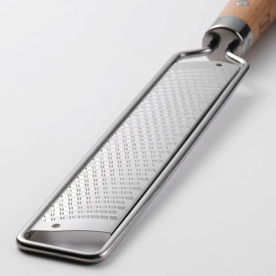 Silver grater with wooden handle, featuring large holes, hanging hole on handle, good grip, sturdy design.