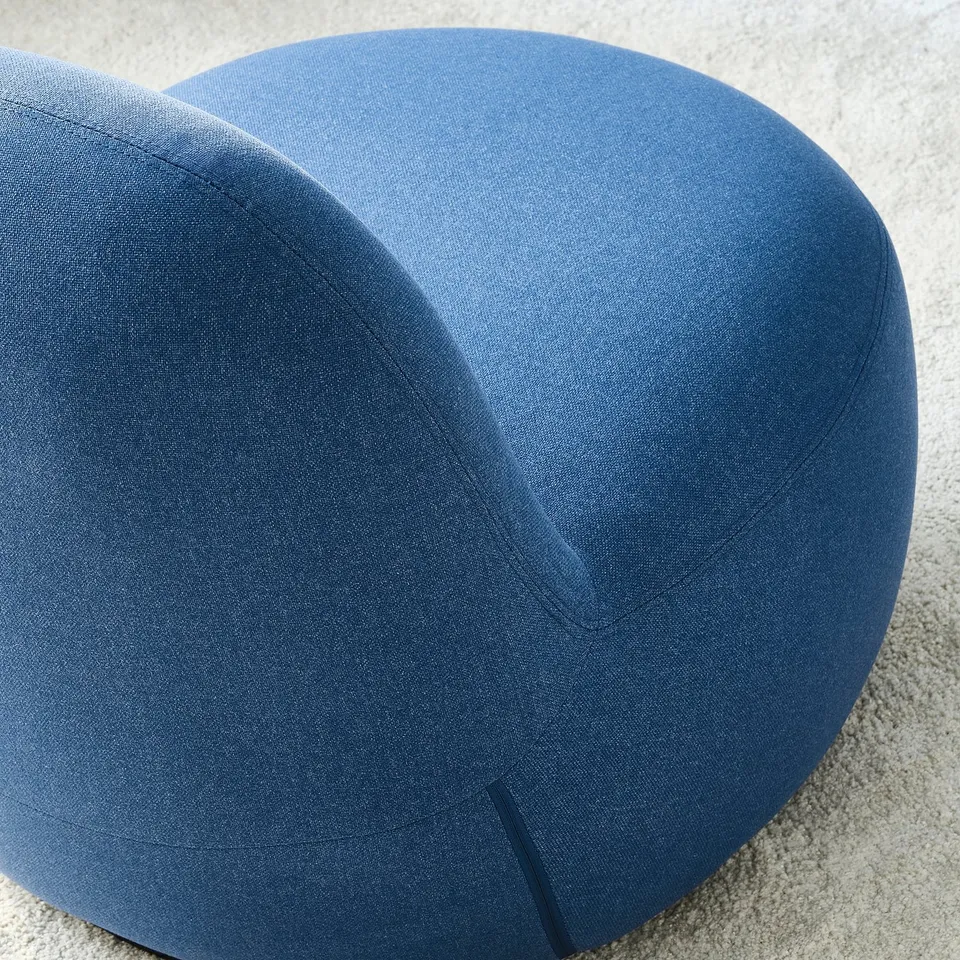 Soft, modern blue chair with quality upholstery, smooth fabric, and inviting shape.