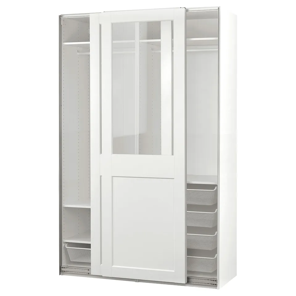 An all-white PAX wardrobe with glass-topped sliding doors, mesh drawers, and hanging space.