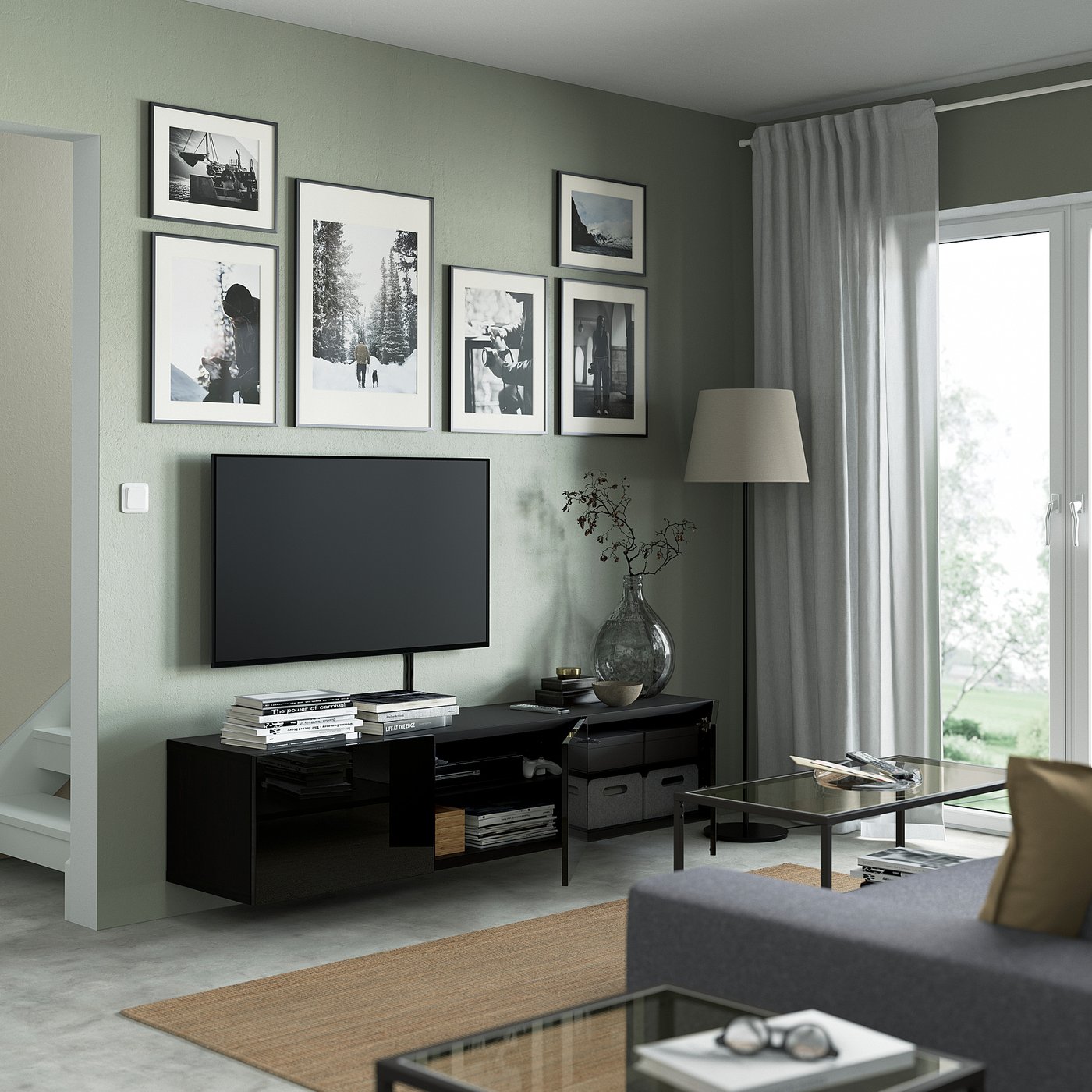 Modern living room with wall-mounted tv unit showcasing minimalist decor, black tv bench with adjustable shelves, and cable management.