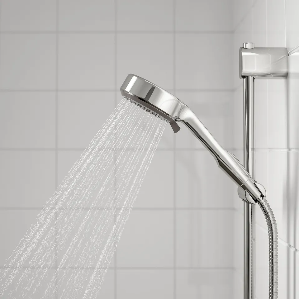 A modern showerhead with a full spray function actively running water, mounted on a metallic holder.