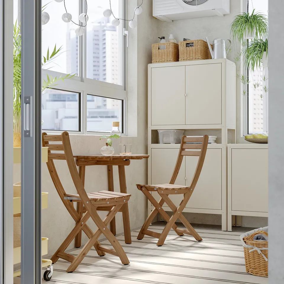 Small wooden dining set with cushions, miniature table & chairs near large window. Bright, clean design.