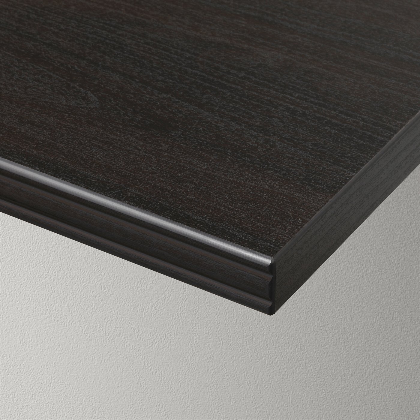 Dark woodgrain table edge detail, smooth finish.