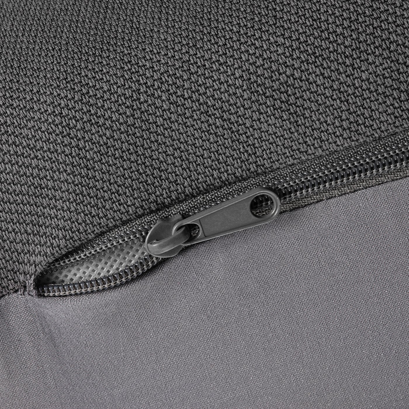 Close-up zip on durable, textured fabric.