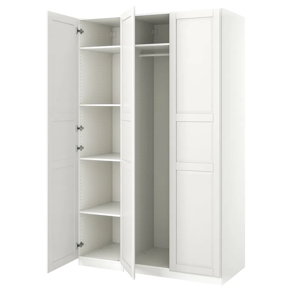 An open white IKEA PAX wardrobe with shelves and a hanging rod inside.