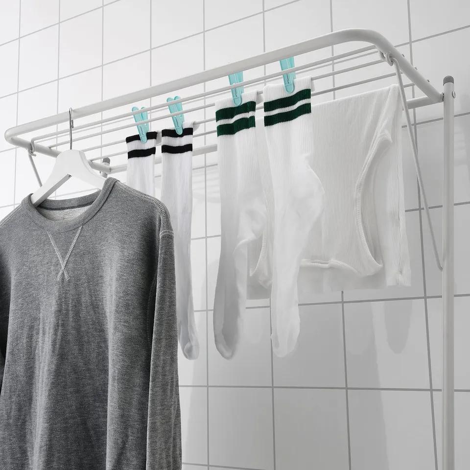 Clothes drying rack with hangers and clips maximises drying space and air-dries garments.