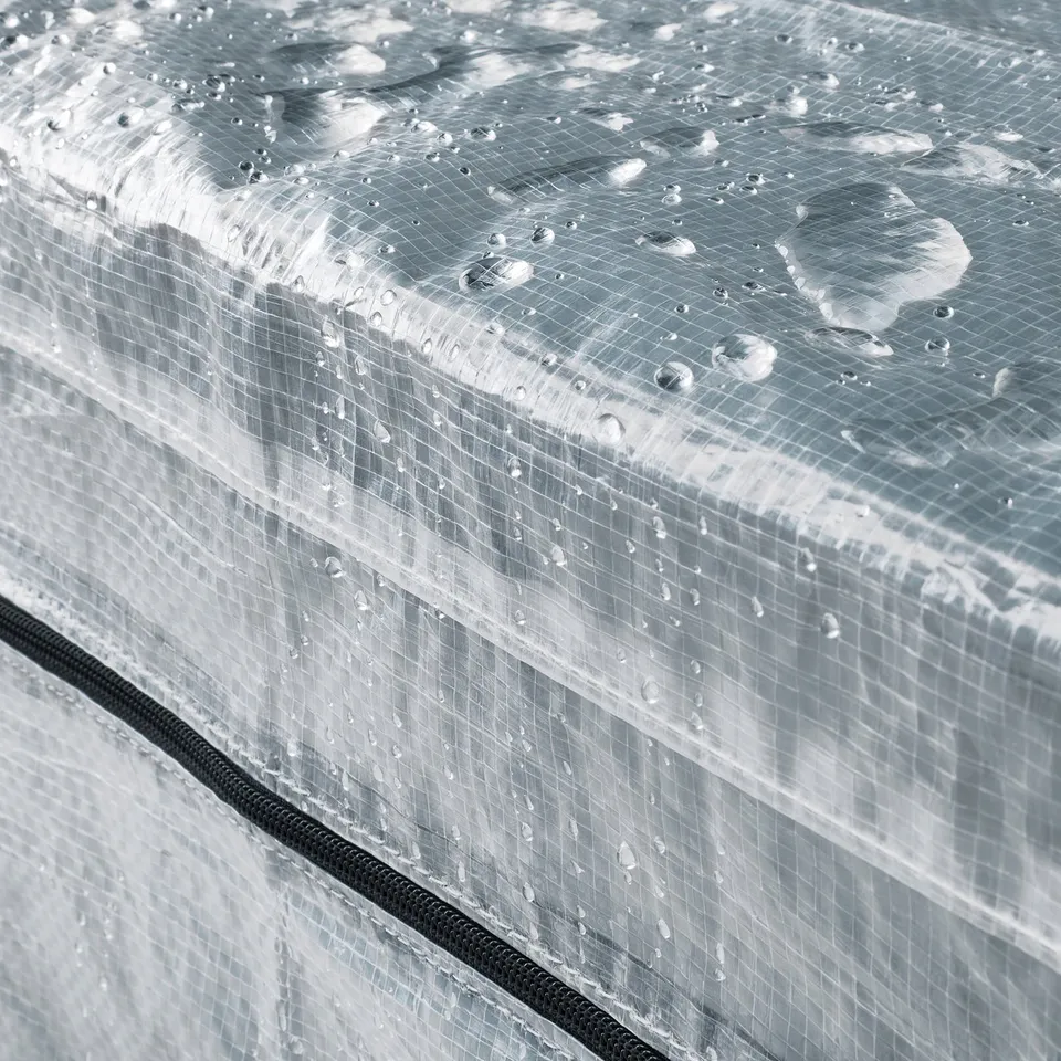 Clear plastic cover with grids, water droplets showing its waterproof, black zip at bottom, ideal for HYLLIS shelving.
