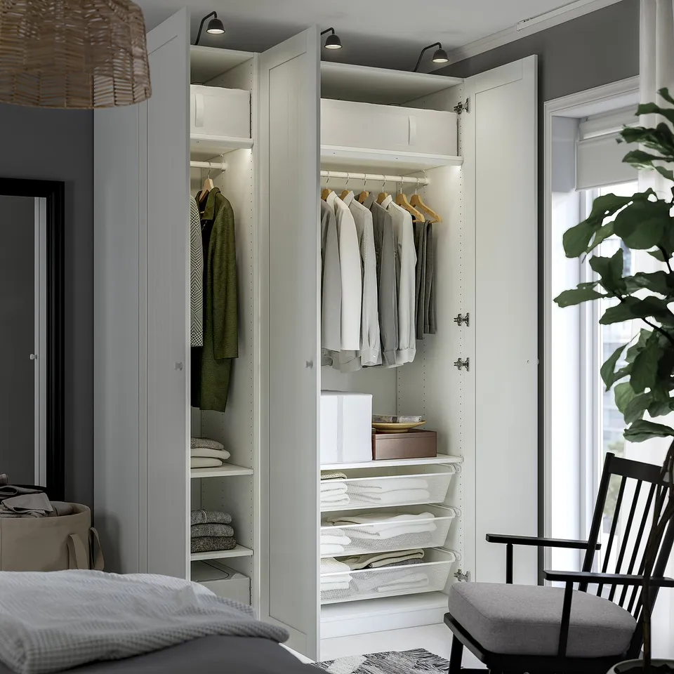 Modern closet with organised clothes, shelves, baskets, and lights.