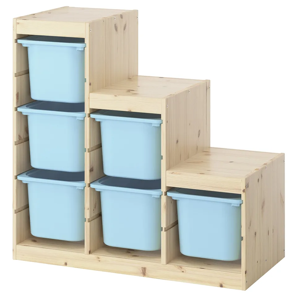 A TROFAST storage unit with light blue plastic bins in a wooden frame, ideal for organising childrens toys.