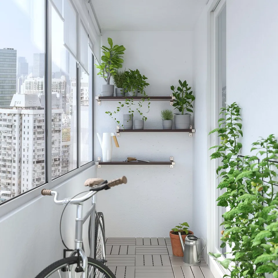 Modern balcony with city view, custom shelves of potted plants, bicycle, and watering can.