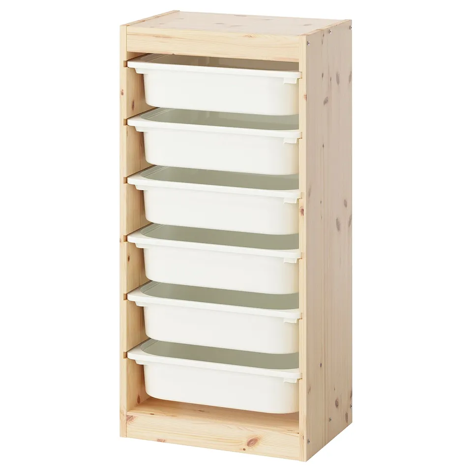 An ikea TROFAST storage unit in light pine with six white plastic bins for organizing childrens toys.