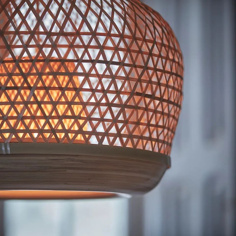 Hand-woven bamboo lamp. Brown with warm glow.