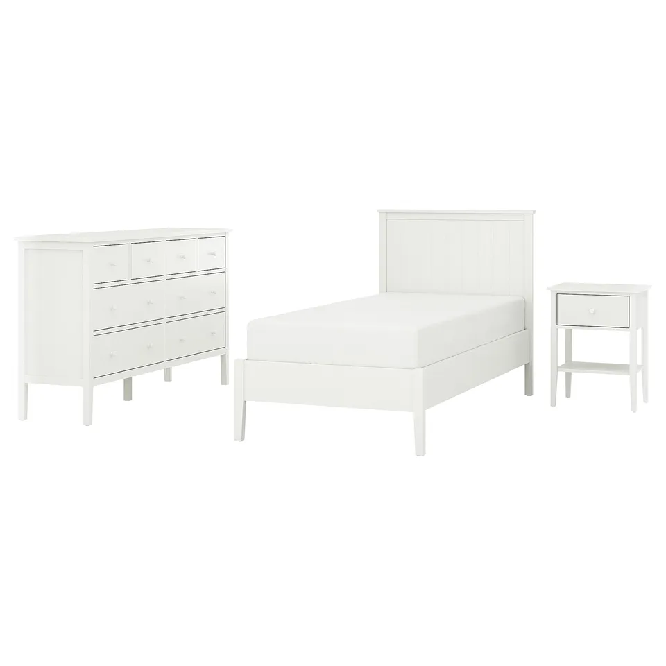A white bedroom set including a bed, a dresser, and a bedside table. The pieces have a modern, minimalist design, with clean lines and simple knobs.
