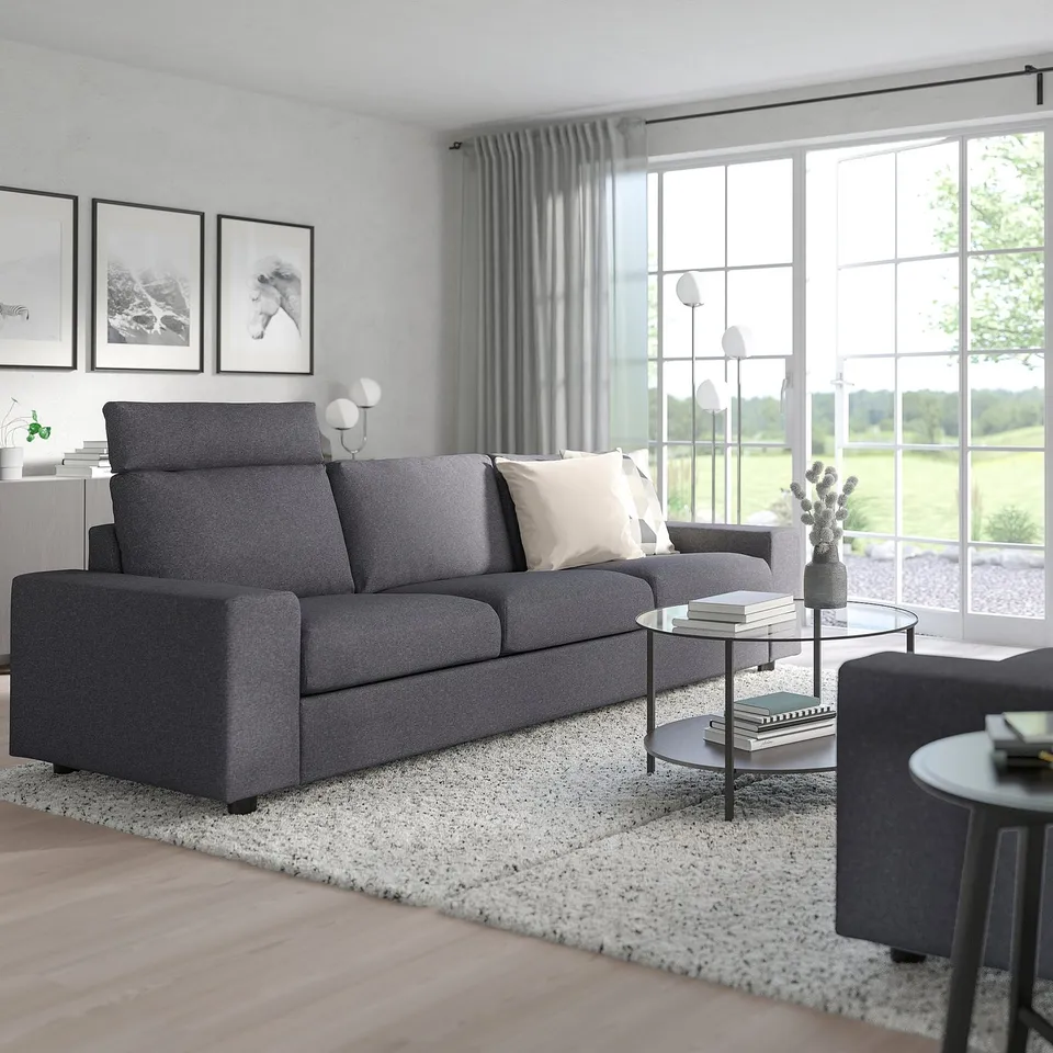Cosy living room with VIMLE charcoal sofa, high headrests, light grey wall, large window, and neutral rug.