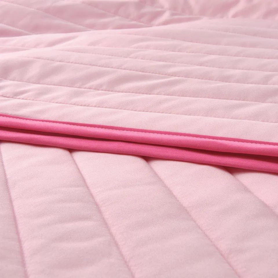 Close-up of soft, pink VETEJORDFLY bedspread with neat stitching and dark pink edge, showcasing high-quality texture.