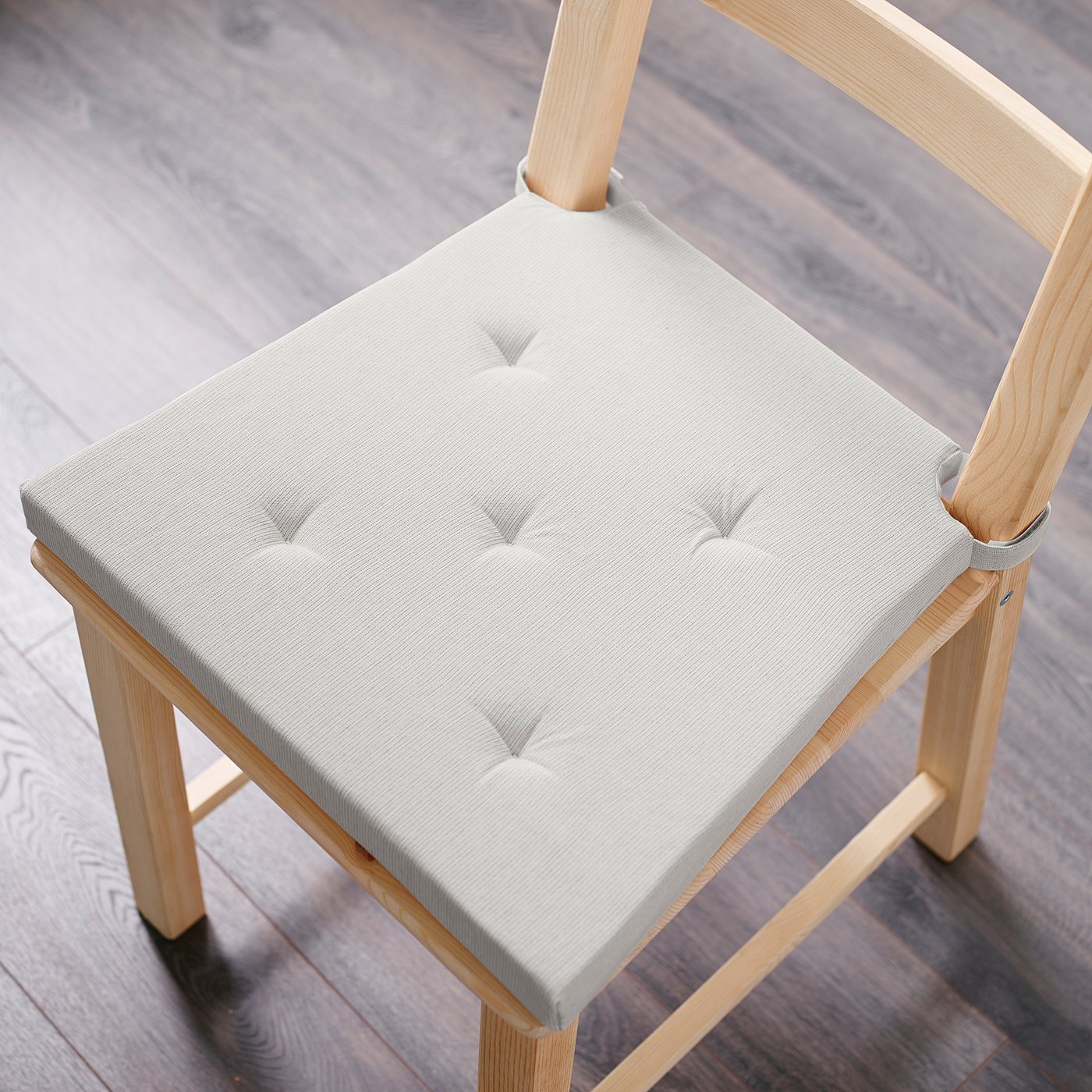 JUSTINA chair cushion in white, soft foam, fits snugly on wooden chair, rectangular.