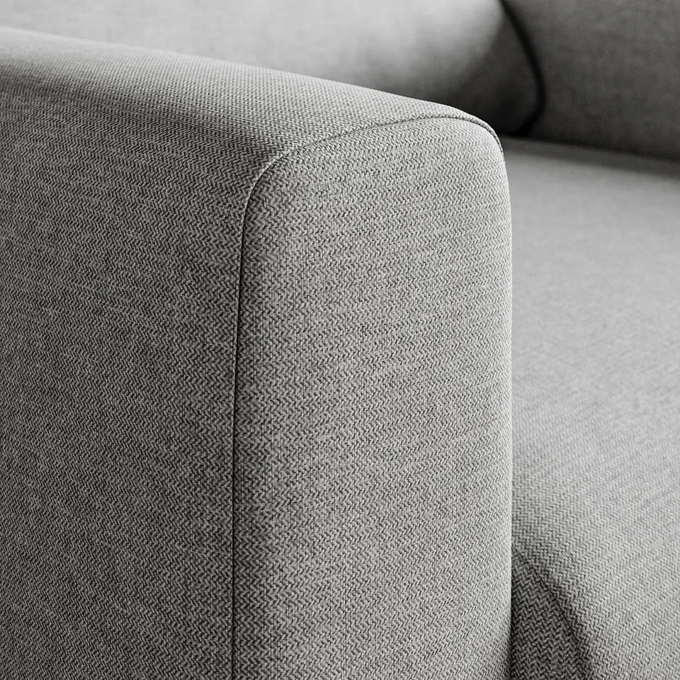 Close-up of a perfect, upholstered chair arm with clean lines and comfy, supportive fabric.