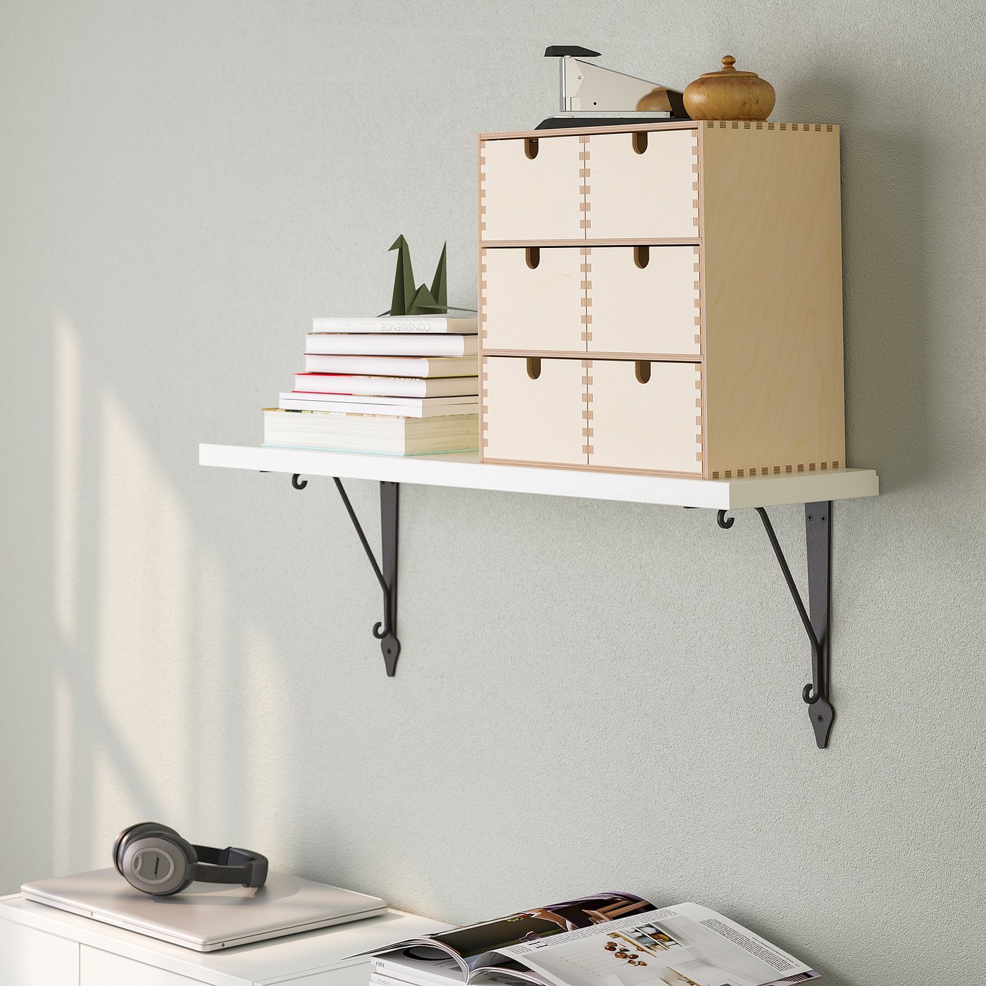 Wall-mounted shelf organiser, displaying books and decor, securely fixed against a wall.