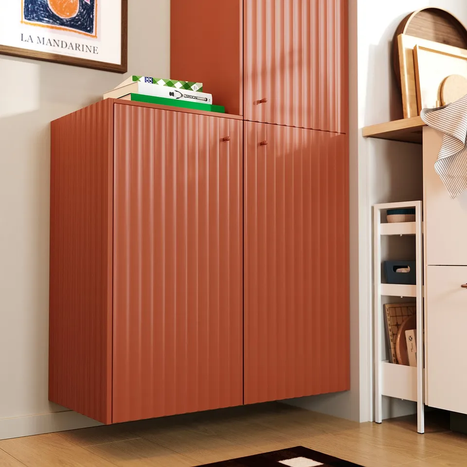 Modern orange NISSAFORS storage trolley with steel frame and mesh shelves, slim for compact spaces.