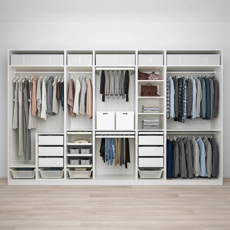 A spacious walk-in closet with hanging, shelf, and drawer storage for organised clothing.