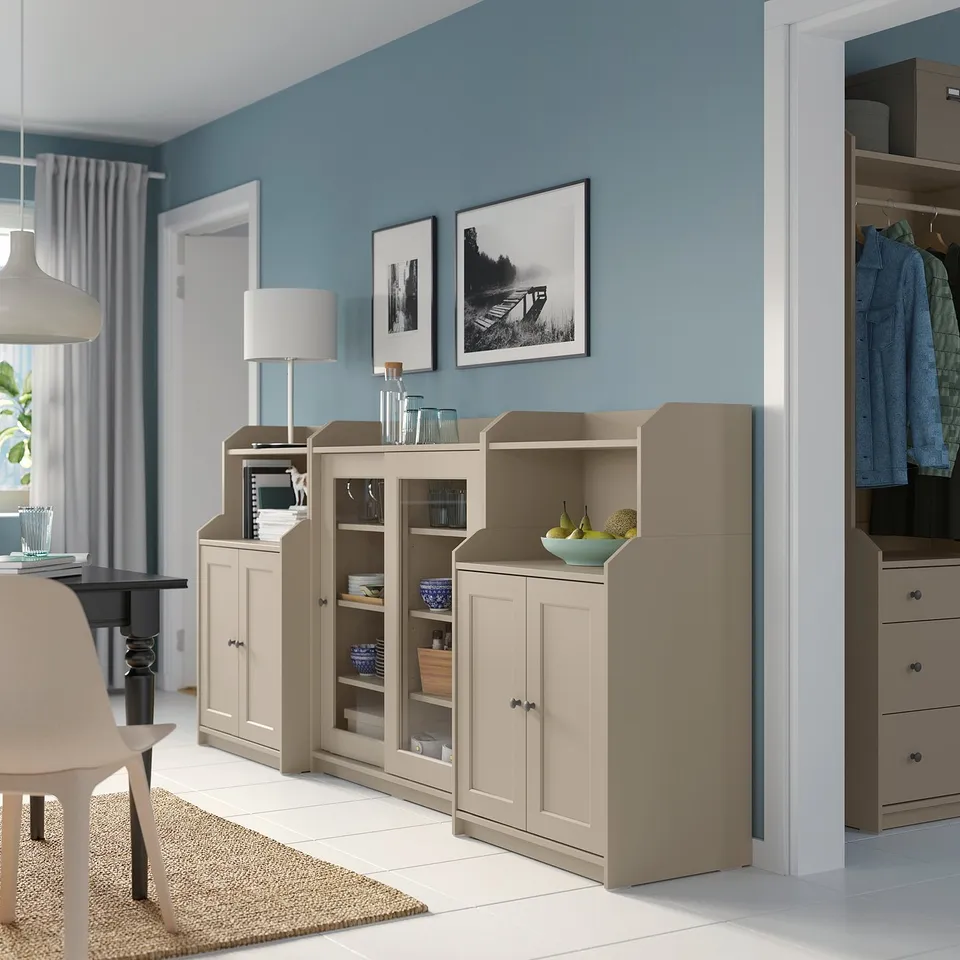 Modern living space with light wood cabinets, open & closed storage, glass doors, adjustable hinges.