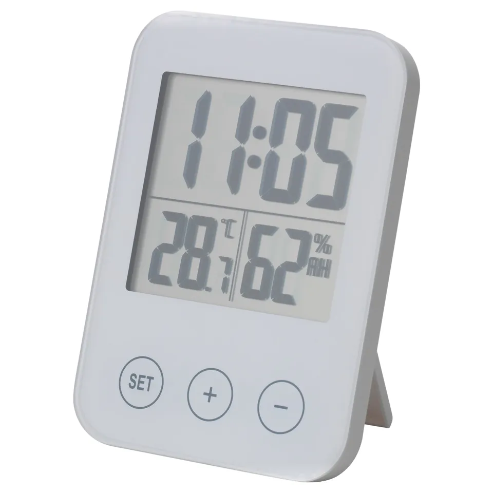 White SLÅTTIS multi-function clock, displays time, temp, humidity, standing design, abs plastic.