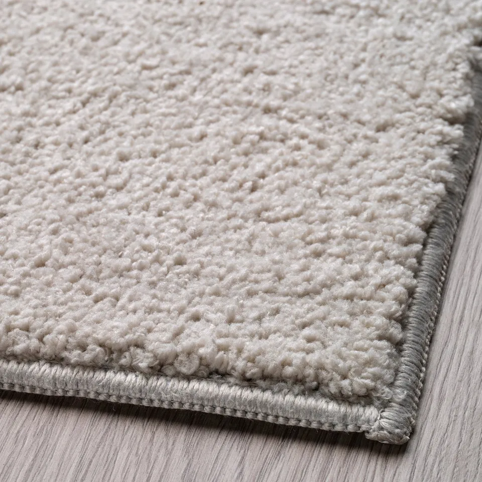 Soft, textured rug with plush pile, ideal for kids play, featuring recycled materials and anti-slip backing.