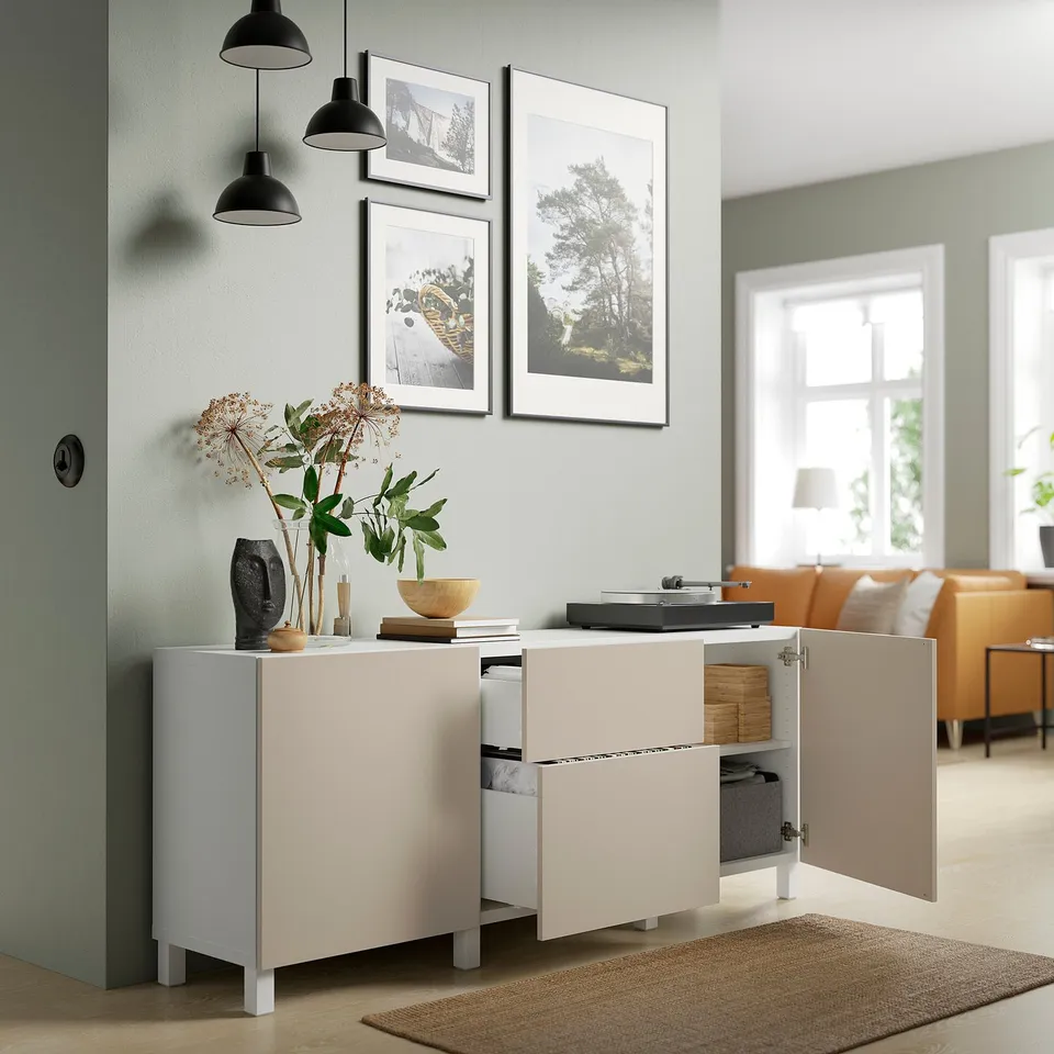 BESTÅ unit with open doors, record player, vase, pendants, photos.