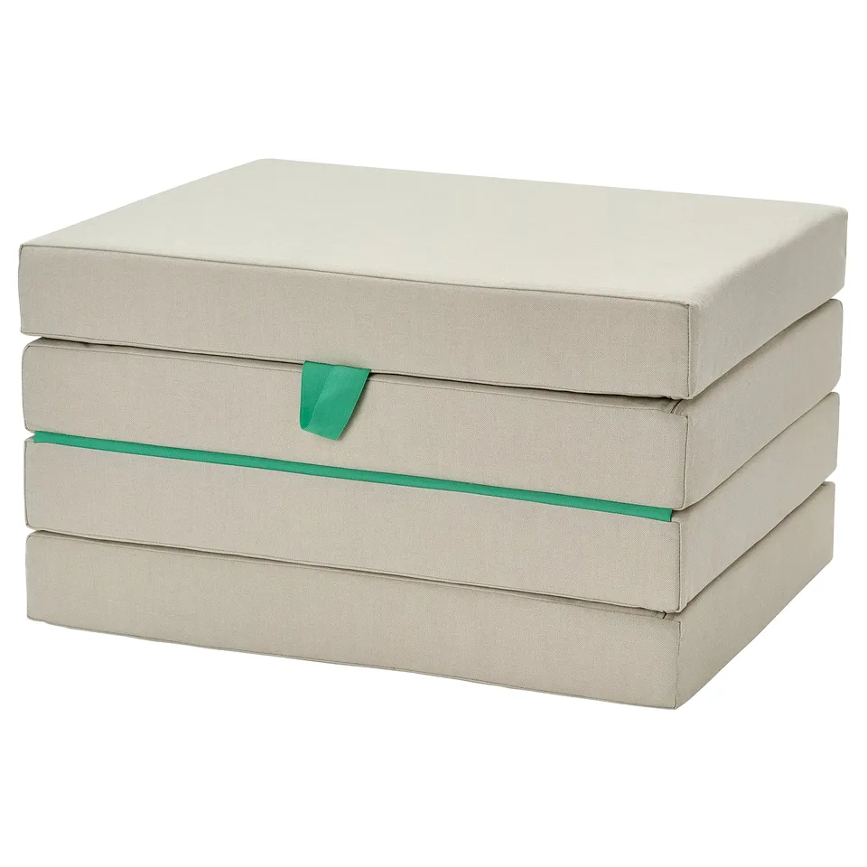 Beige foldable childs floor mattress with green accents, rectangular shape.