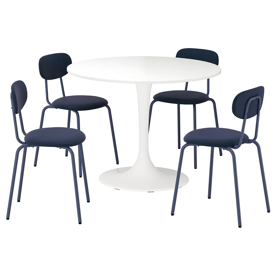 A modern white round table with four blue upholstered chairs, each featuring a steel frame.
