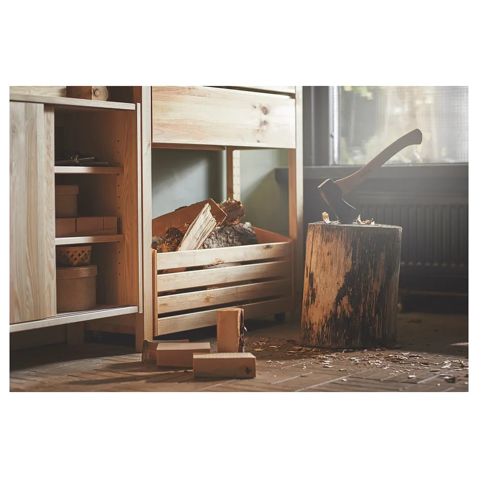 The IVAR storage system, featuring light wood shelves and a wooden crate filled with kindling.