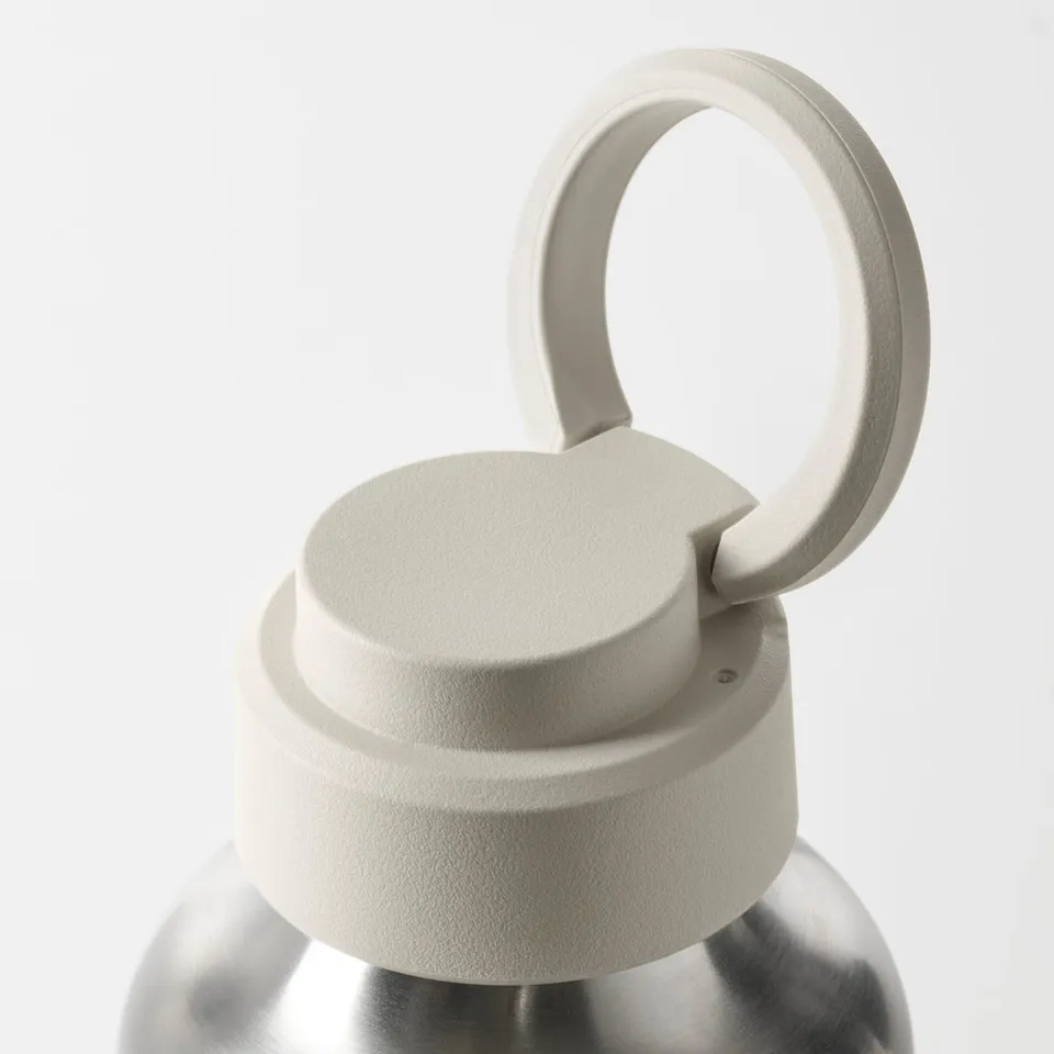 Close-up of a durable stainless steel water bottle with a secure silicone seal and a sturdy, attached plastic lid handle.