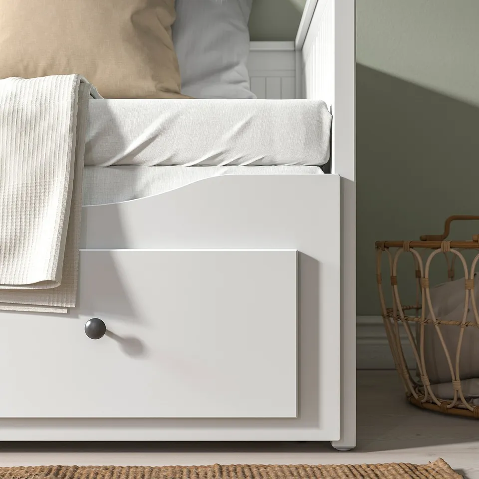 Modern white daybed with drawer open.