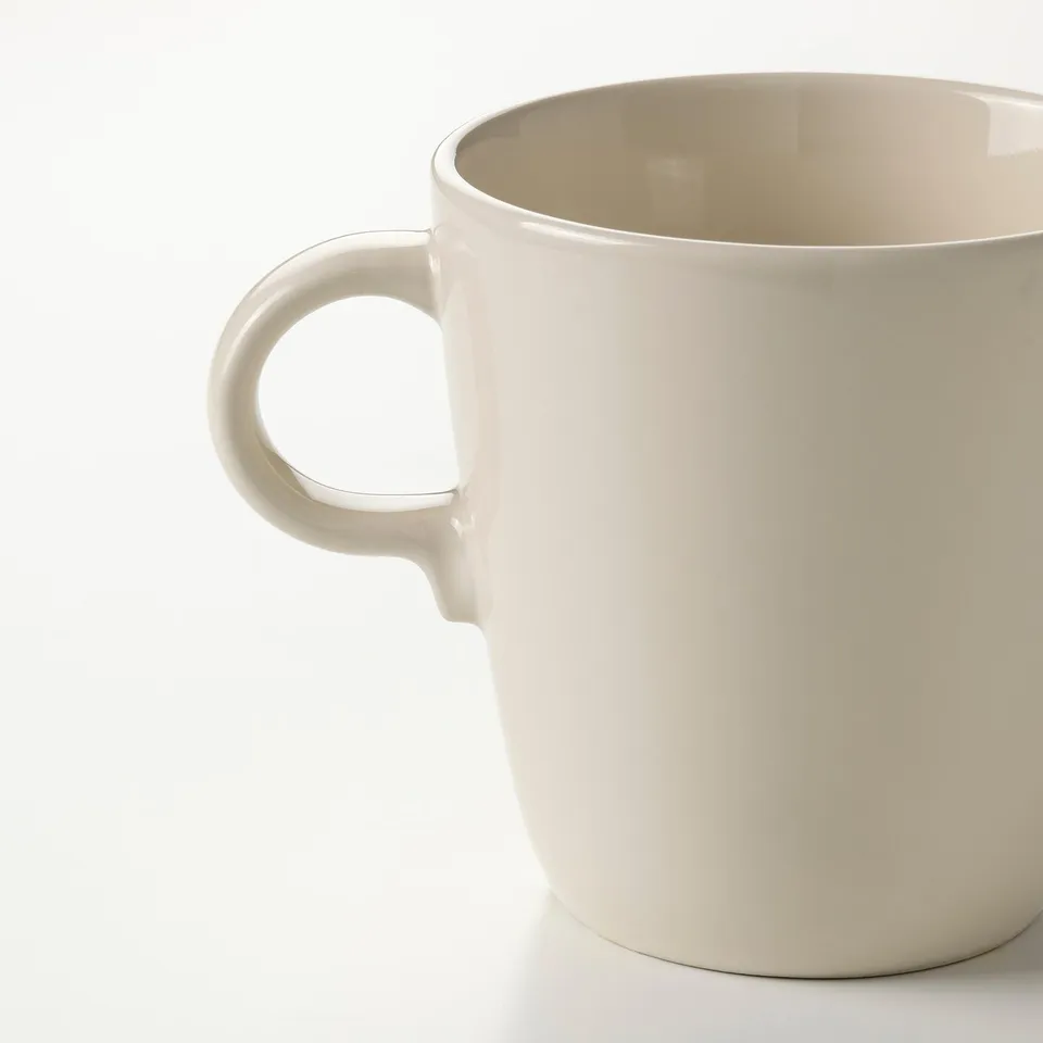Simple white mug, smooth surface, sturdy handle, perfect for coffee or tea.