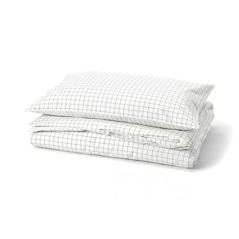 A folded white and anthracite chequered duvet cover and pillowcase set. The design stitched checks on one side and stripes on the other.