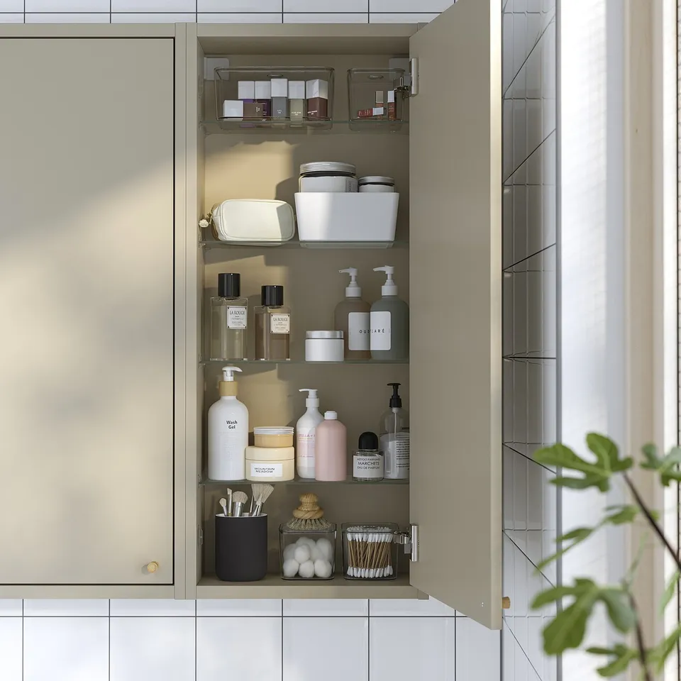 Bathroom cabinet with toiletries, cosmetics, and adjustable shelf.